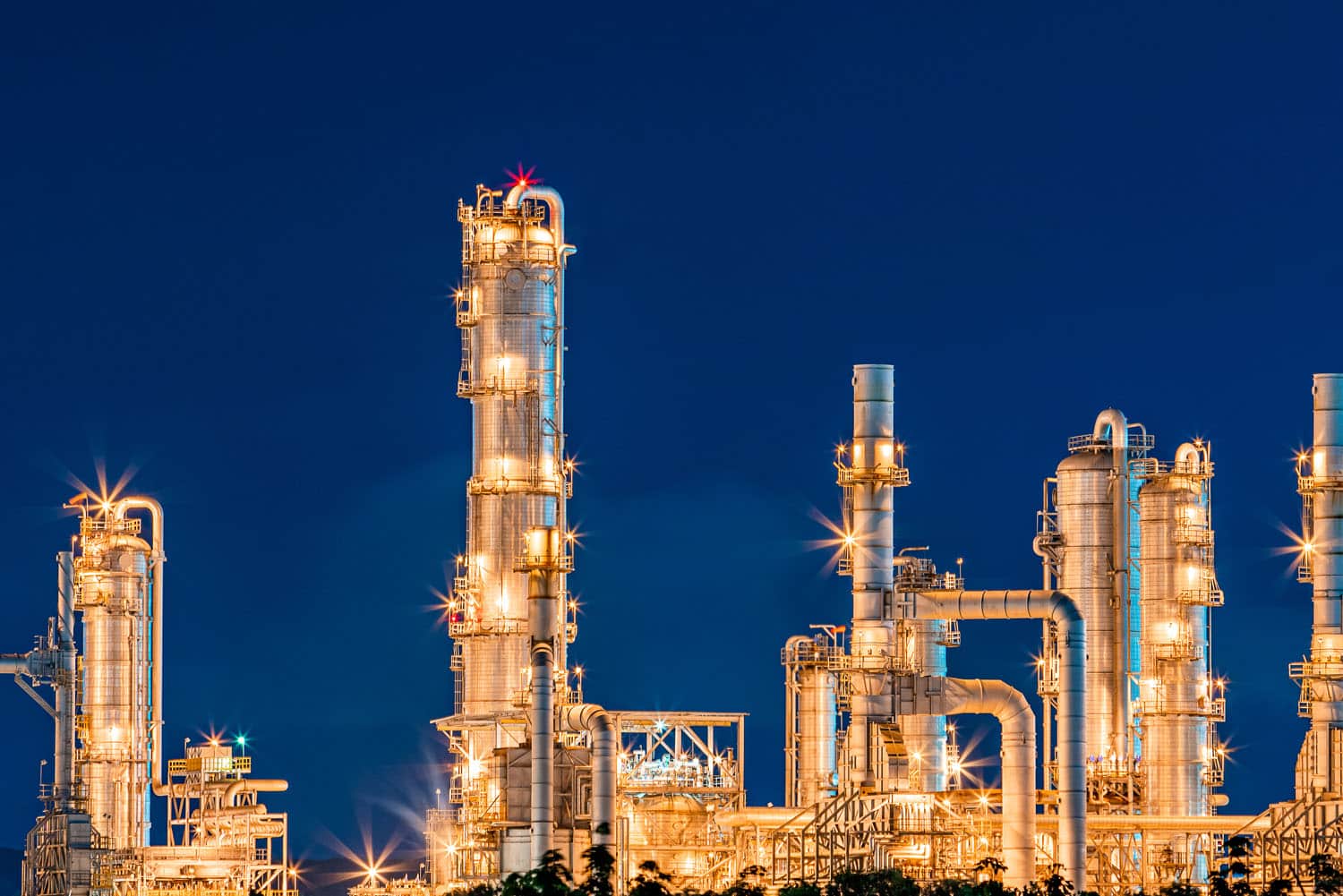 refinery oil and gas industry at night blue sky after sunset time with chemical and petroleum for energy of transportation and electricity product, as business economy industrial